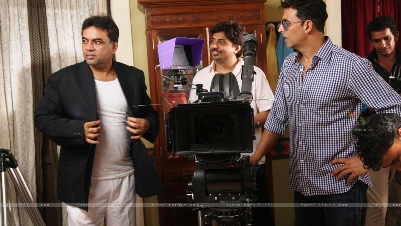 Actors Paresh Rawal and Akshay Kumar inspect a scene on the set of 'Oh My God'